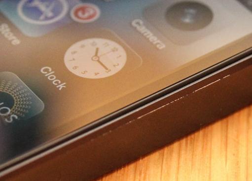 Close-up of a used iPhone edge with a visible scratch as an illustrative Grade B reference